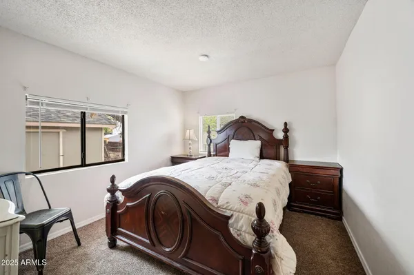 a bedroom with a bed and chair