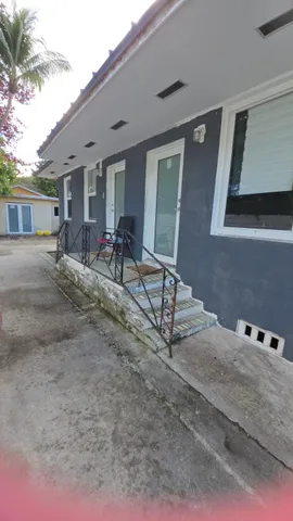 a view of two chairs in front of house