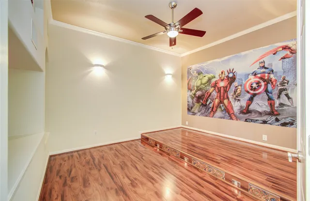 a view of an empty room with wooden floor
