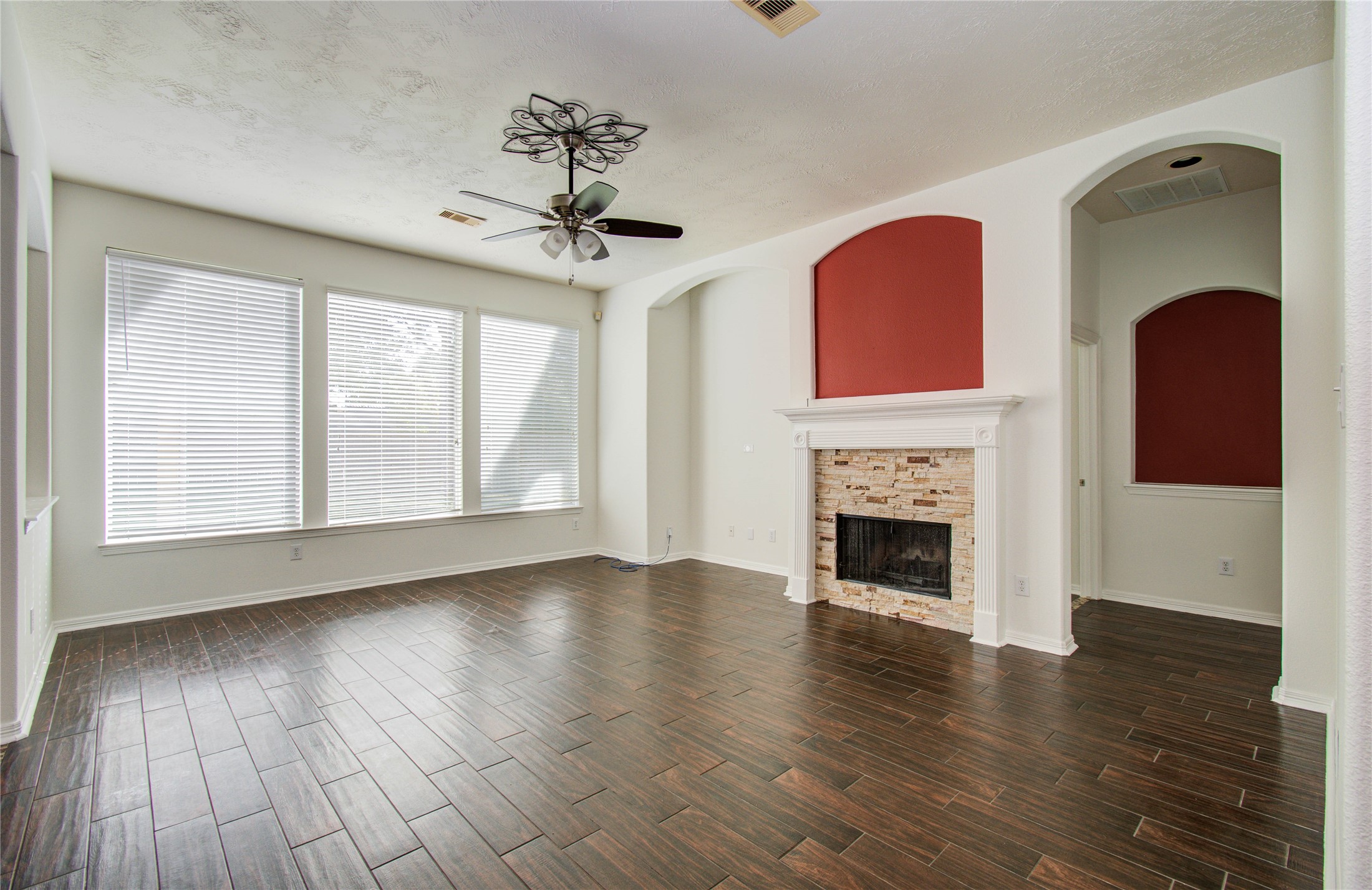 10714 Barker Lake Cypress, TX 77433 - Photo 20 of 43 a view of an empty room with wooden floor fireplace and a window
