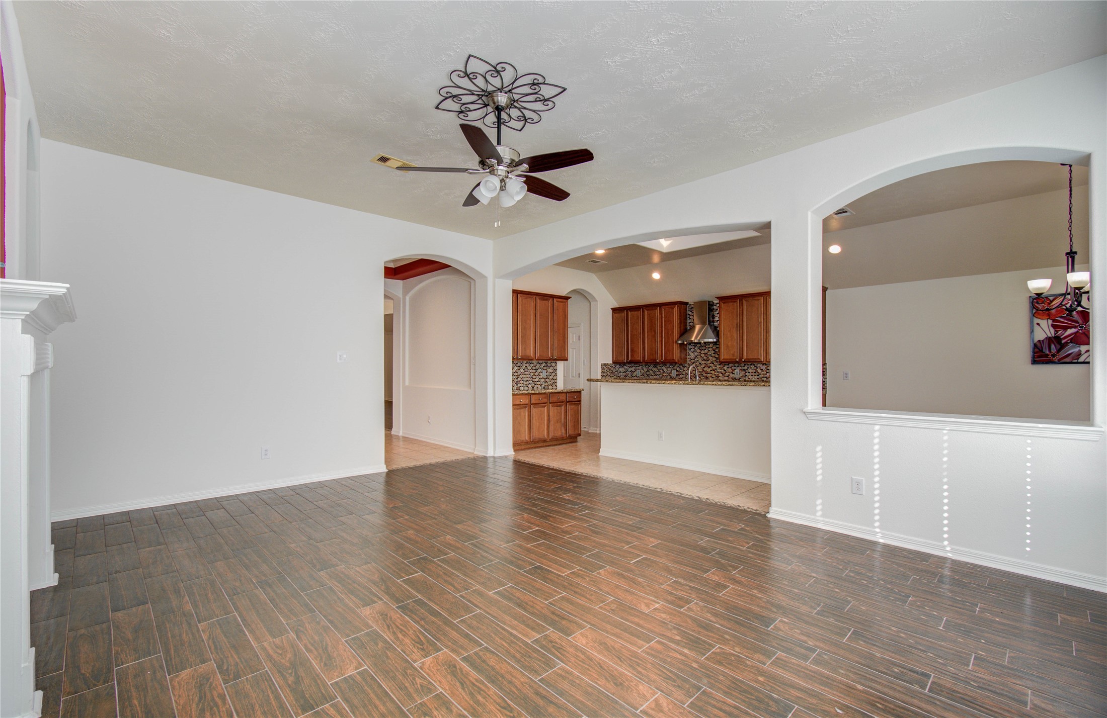 10714 Barker Lake Cypress, TX 77433 - Photo 22 of 43 a view of a hallway with wooden floor and a kitchen