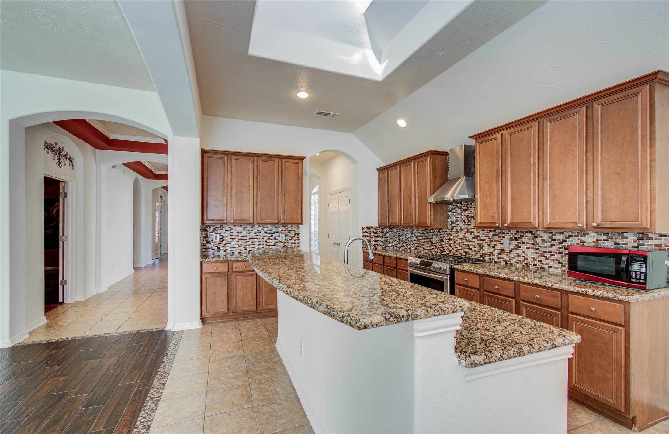 10714 Barker Lake Cypress, TX 77433 - Photo 26 of 43 a kitchen with stainless steel appliances granite countertop a stove and a refrigerator