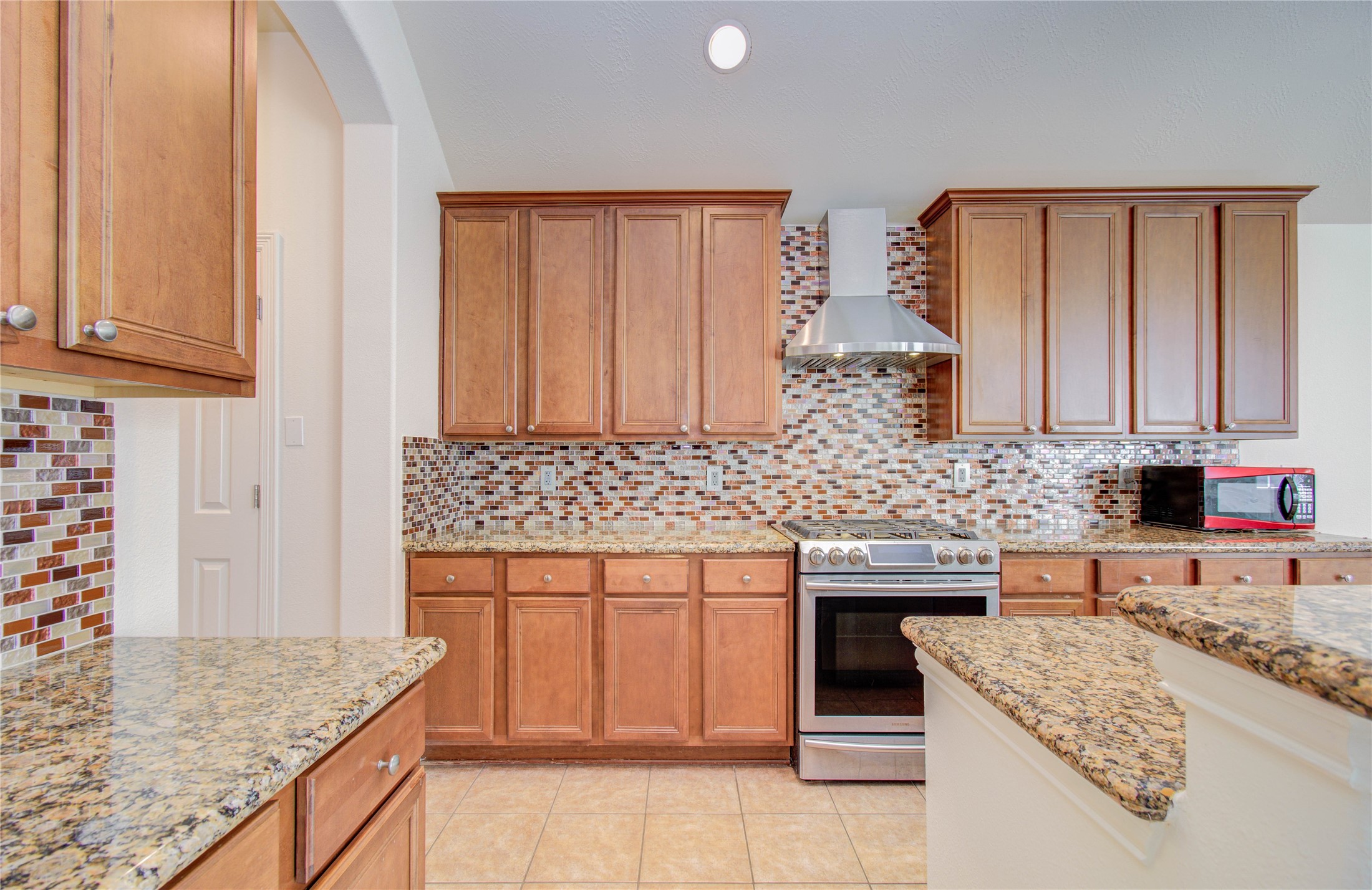 10714 Barker Lake Cypress, TX 77433 - Photo 28 of 43 a kitchen with stainless steel appliances granite countertop a sink and cabinets