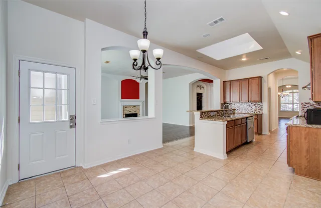 a large kitchen with cabinets and stainless steel appliances