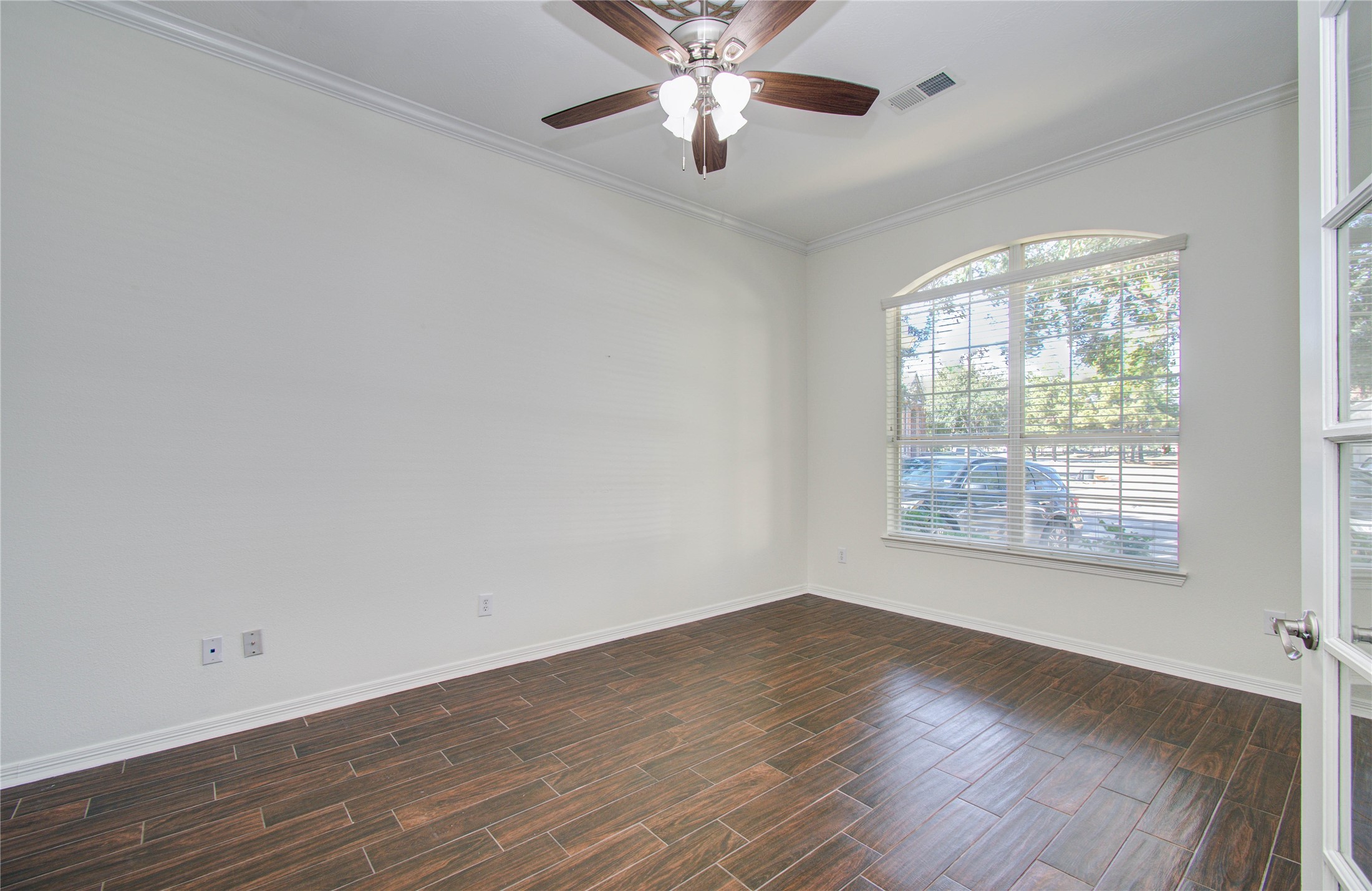 10714 Barker Lake Cypress, TX 77433 - Photo 6 of 43 an empty room with wooden floor chandelier fan and windows