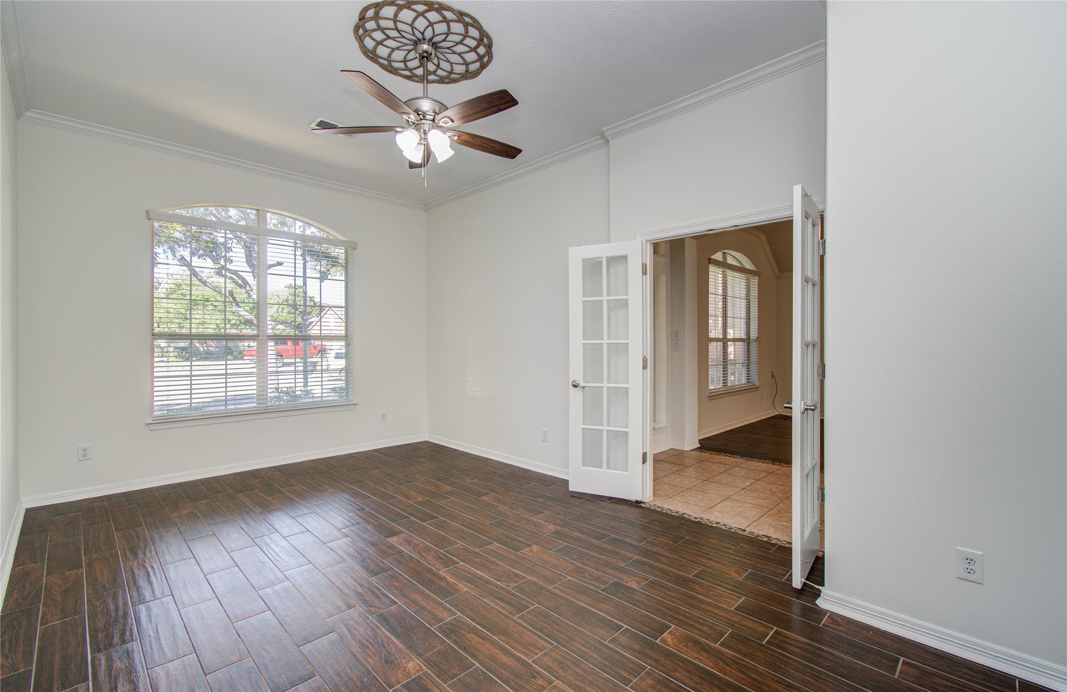 10714 Barker Lake Cypress, TX 77433 - Photo 7 of 43 a view of an empty room with wooden floor and a window
