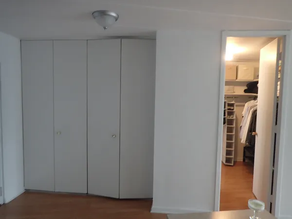 a view of a hallway with a livingroom and a bathroom with a sink