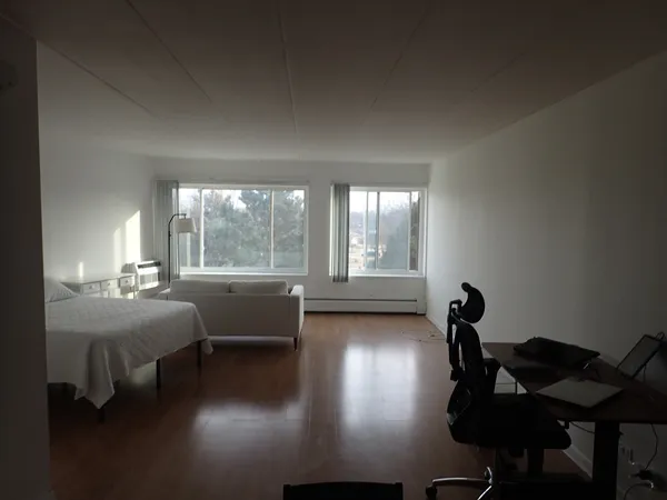 a bedroom with furniture and a window