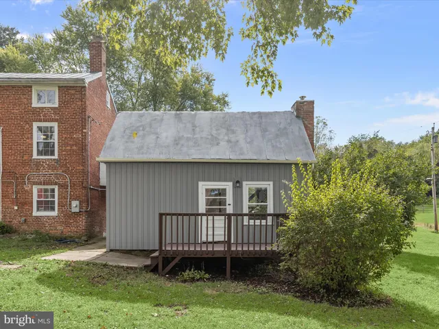 an aerial view of green landscape with trees houses and lake view