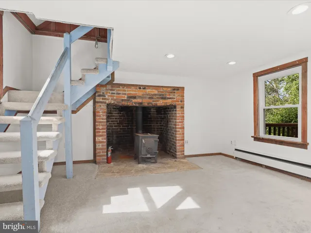 an aerial view of green landscape with trees houses and mountain view