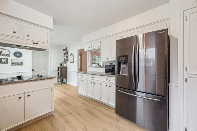 a kitchen with stainless steel appliances a refrigerator sink and cabinets