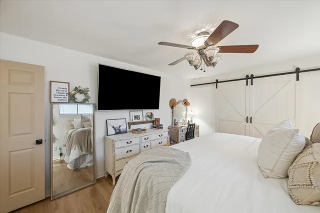 a bedroom with a bed and a flat screen tv