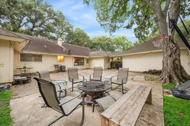 a view of a patio with table and chairs with wooden fence and plants