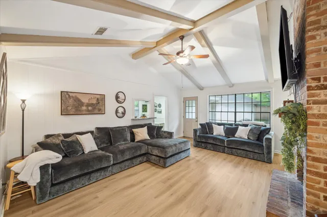 a living room with furniture a couch and a flat screen tv