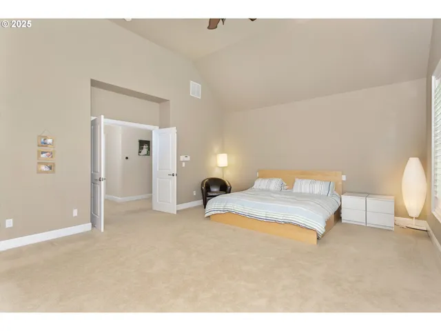 a bedroom with a bed and a large window