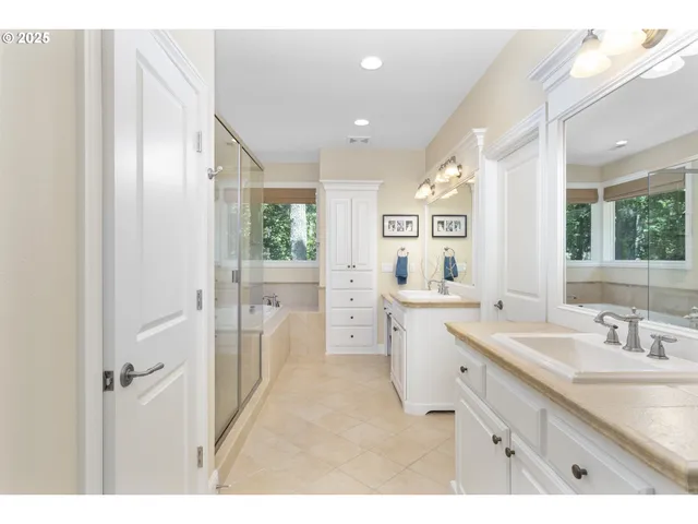 a bathroom with a tub shower and sink
