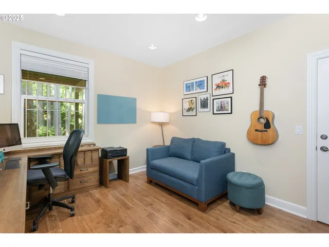 a living room with furniture and a book shelf