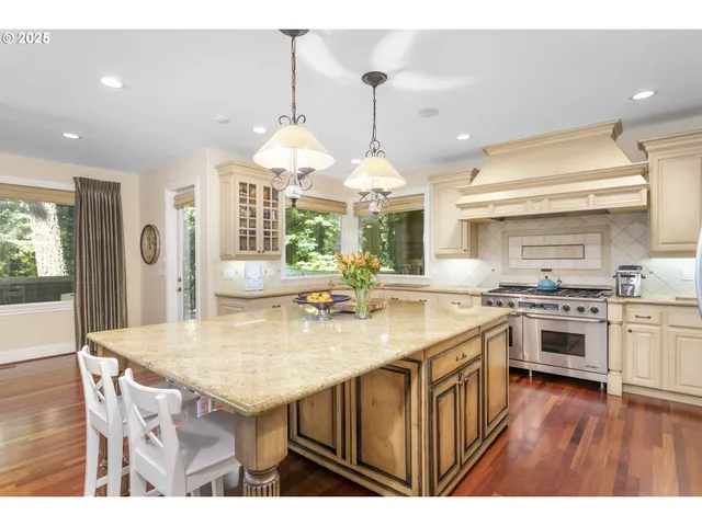 a kitchen with a stove a kitchen island a sink and a refrigerator