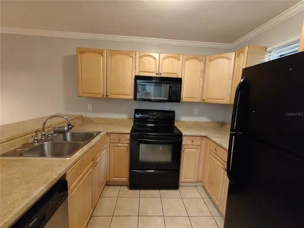 a kitchen with a stove a sink and a microwave