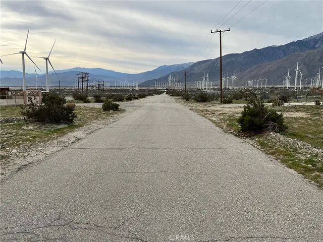 a view of a street with a pole on the road