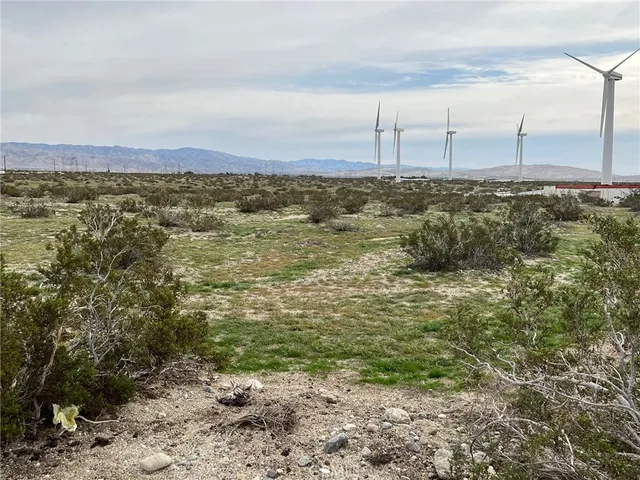 a view of a field with an ocean view