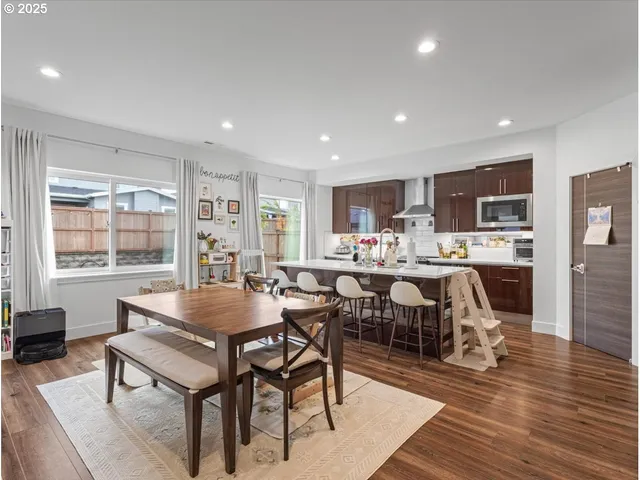 a large kitchen with a table and chairs