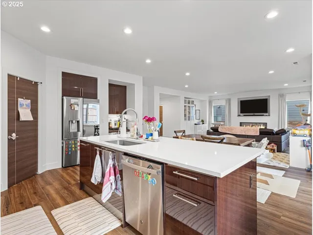 a kitchen with a dining table chairs and refrigerator