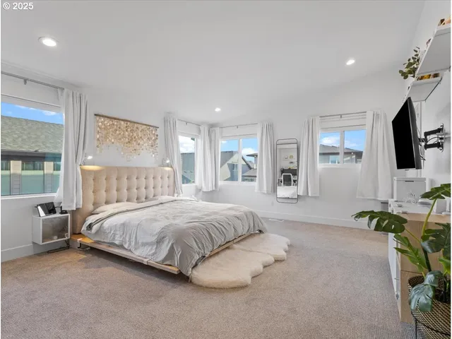 a bedroom with a bed a table and chair