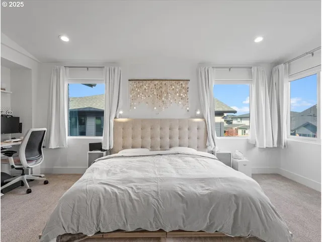 a spacious bedroom with a bed and a flat screen tv