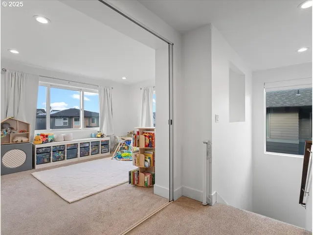 a living room with furniture a rug and a large window