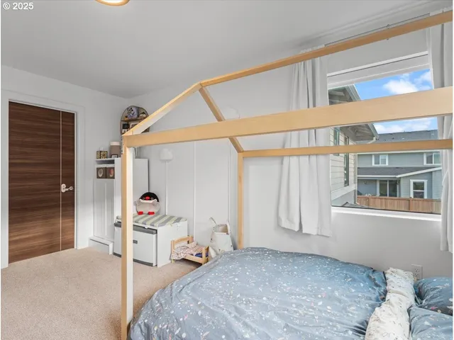 a spacious bedroom with a bed and glass door