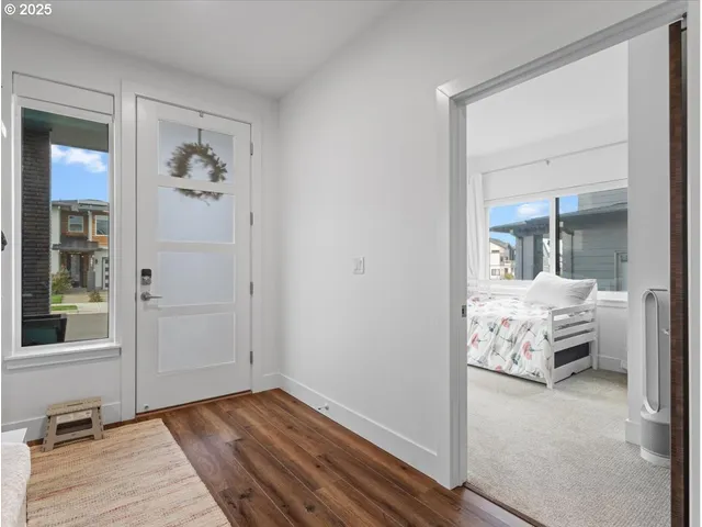 a bedroom with a bed a large window and chair