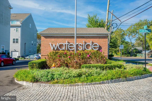 a view of a lake with boats and trees in the background
