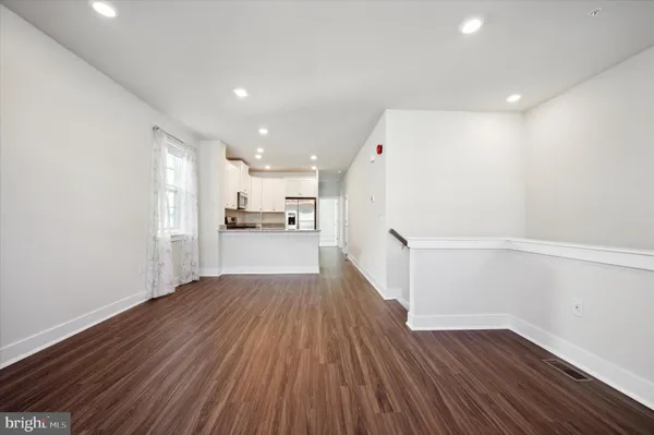 a view of a kitchen with wooden floor
