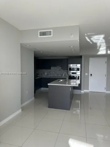 a large kitchen with stainless steel appliances