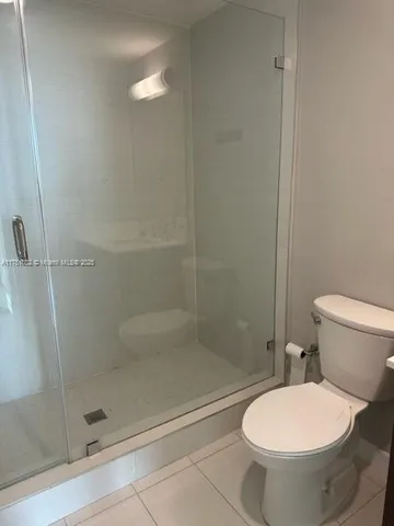 a bathroom with a toilet and a shower