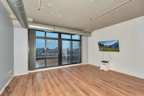 a large kitchen with stainless steel appliances kitchen island a large counter top and a wooden floors