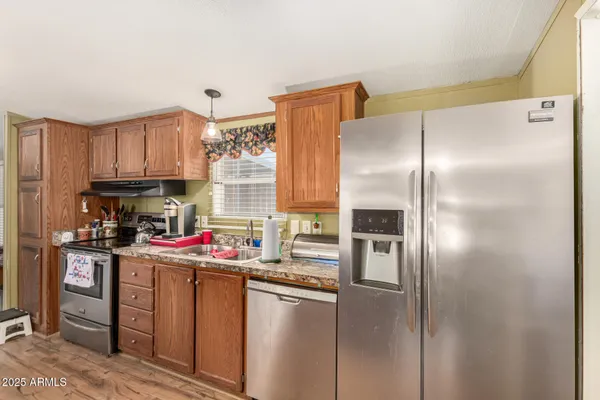 a kitchen with a refrigerator and cabinets