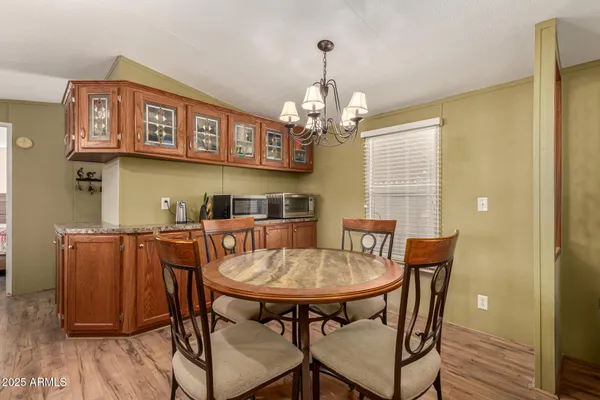 a view of a dining room with furniture wooden floor and chandelier