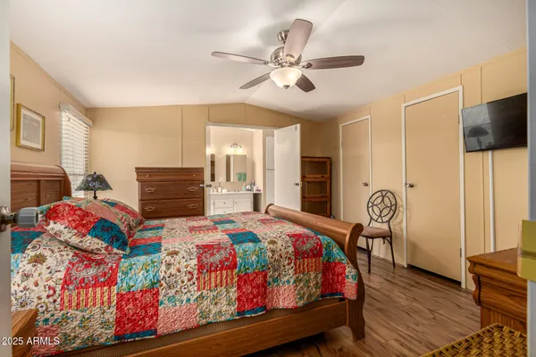 a bedroom with a bed and wooden floor