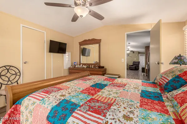 a bedroom with a bed and a chandelier