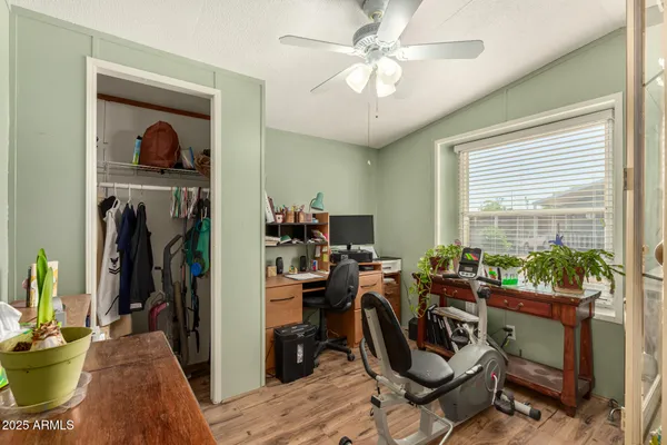 a view of a workspace with furniture and a window