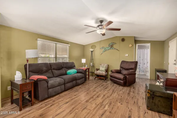 a living room with furniture and a wooden floor