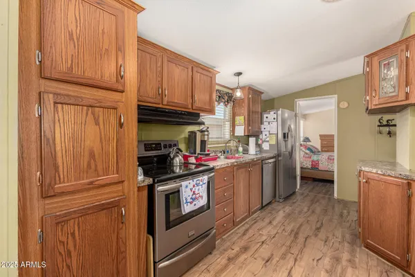 a kitchen with stainless steel appliances granite countertop a stove and a refrigerator