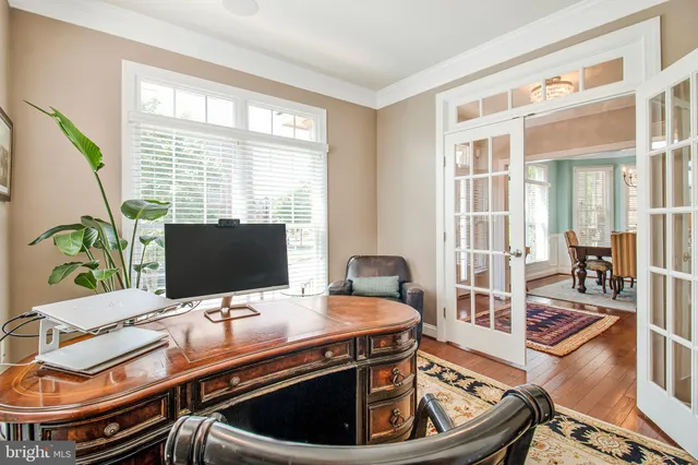 a view of a workspace with furniture and a window