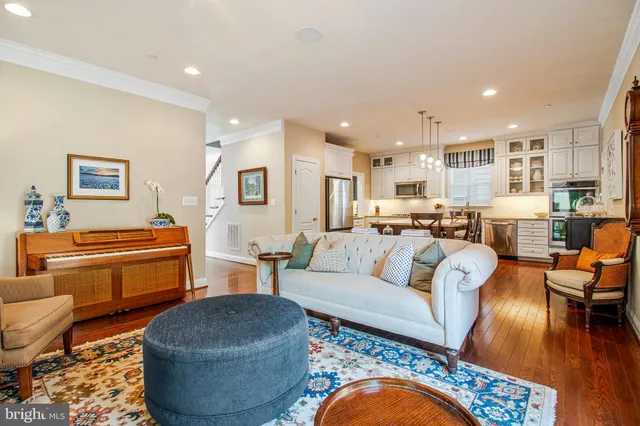 a living room with furniture kitchen view and a table
