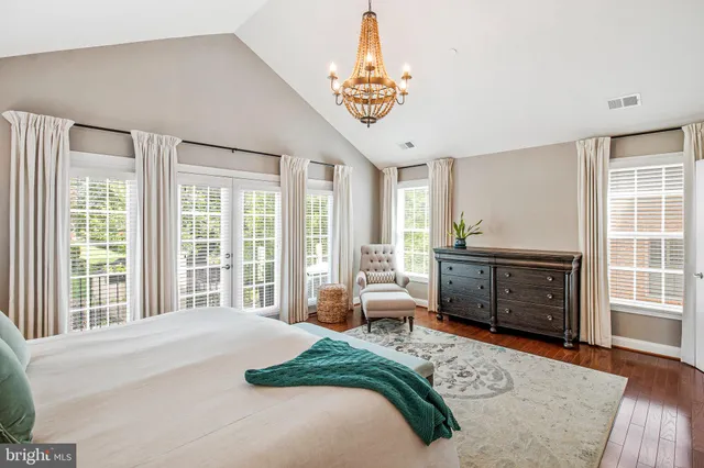 a bedroom with a bed and a large window