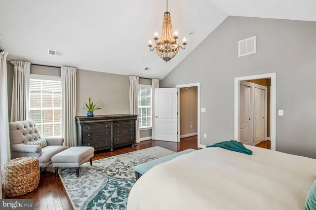 a bedroom with a bed dresser and window