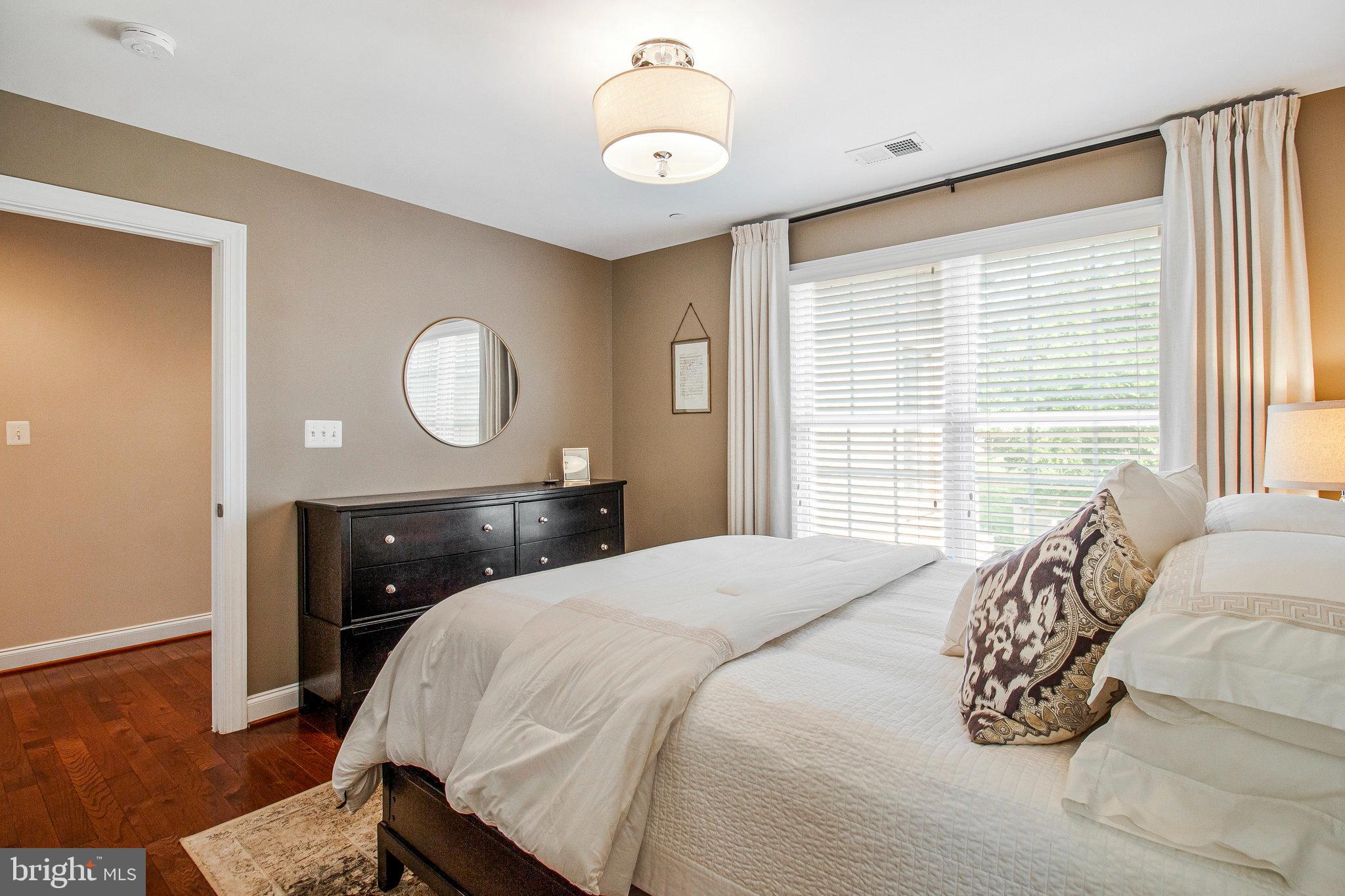 208 Beacon Place Northeast Washington, DC 20011 - Photo 33 of 48 a bedroom with a bed and a chandelier