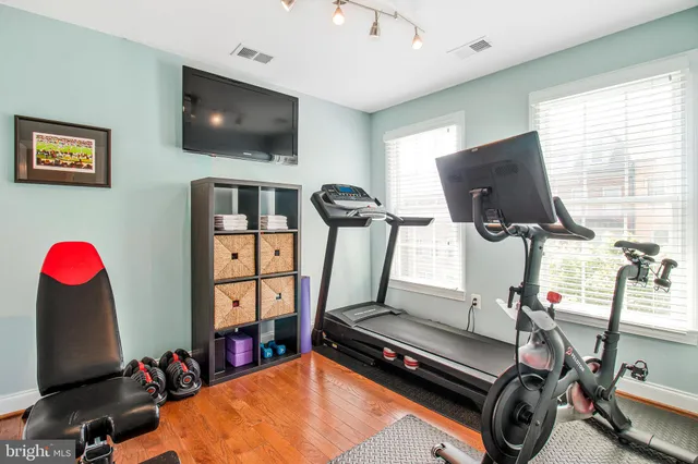 a room with gym equipment and a flat screen tv